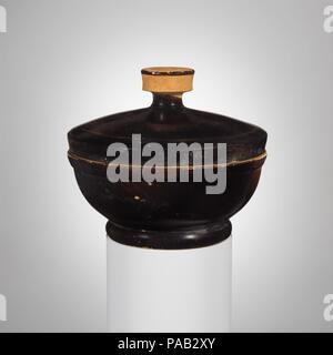 Bol à couvercle en terre cuite. Culture : le grec, le grenier. Dimensions : H. avec couvercle 3 7/8 in. (9,8 cm) ; H. sans couvercle 2 1/4 in. (5,7 cm). Date : ca. 450-400 av. J.-C.. Ce vase est liée à la bol à couvercle avec une poignée (23.43a, b) affichée à proximité. Ils représentent essentiellement la même forme adaptée aux différentes fonctions par la présence ou l'absence d'une poignée. Musée : Metropolitan Museum of Art, New York, USA. Banque D'Images