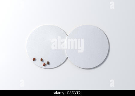 Deux sous-verres blanc et les grains de café sur fond blanc. 3d illustration Banque D'Images