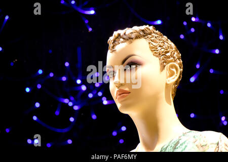 Close up d'une poupée mannequin femme avec les cheveux courts n'affiche la vitrine avec éclairage bleu flou en arrière-plan , vue de profil Banque D'Images