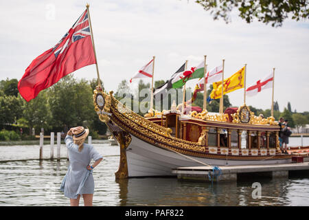 Un spectateur regarde la Reine Gloriana 'rowbarge' comme les gens profiter du beau temps au cours de la Thames Festival de bateau traditionnel au Henley on Thames, Oxfordshire. Banque D'Images