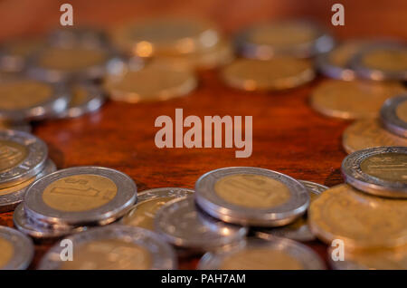 Pièces mexicain dans un rond sur une table de bois faisant un trou dans le milieu Banque D'Images