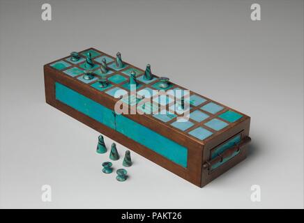 Terrain de jeu et des jeux de pièces. Dimensions : boîte restauré : L. de 43 cm (16 15/16 in.) ; W. 13,5 cm (5 5/16 in.) ; H. 9 cm (3 9/16 in.). Dynastie DYNASTIE : 18. Règne : règne de Thoutmosis III. Date : ca. 1550-1295 av. J.-C.. Les incrustations de faïence bleue de ce jeu fort et les dominos (01.4.1b-h et 01.4.1i-p) ont été découvertes dans un tombeau à Abydos. Ce tombeau contenait également un scarabée inscrit avec le cartouche de Thoutmosis III, un papyrus brunissoir est inscrit le nom et titre du scribe, un Merymaat Silver Earring, et un pot de peinture. Seulement certains des incrustations de faïence de la boîte d'origine ont été préservés. L'un Banque D'Images