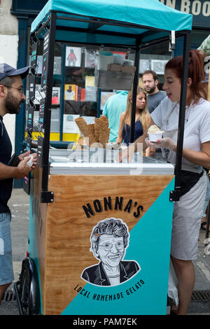 Hackney, Londres. Marché de Broadway. Une jeune femme vend Nona's home-made gelato à partir d'un panier ; Banque D'Images