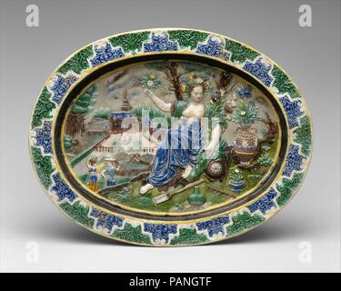 Plat à Pomona. Artiste : après une gravure par Philips (Galle, Russisch Haarlem 1537-1612 Anvers) ; après une composition par Maerten de Vos (Anvers, Russisch 1532-1603 Anvers). Culture : français, Fontainebleau ou Avon. Dimensions : hors tout (confirmé) : 2 5/16 x 13 1/2 x 10 1/4 in. (5,9 x 34,3 x 26 cm). Bouilloire : Modalités de Bernard Palissy (Français, Agen, Lot-et-Garonne 1510-1590 Paris). Date : fin 16e ou début du 17e siècle. Pomona, la déesse romaine des fruits, a été associée de façon plus générale de vergers et de jardins à la Renaissance. Ici, elle est entourée de fleurs et de jardinage Banque D'Images