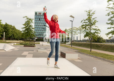 Carefree senior woman wearing red sweat à l'extérieur Banque D'Images