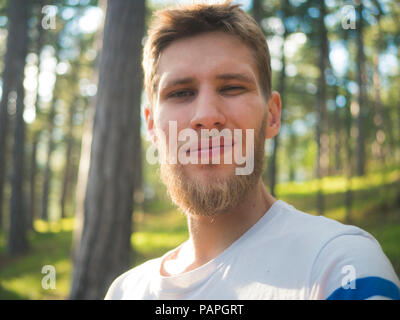 Jeune homme hipster barbu taking self portrait dans la forêt circulant en Suisse lieux nature Banque D'Images