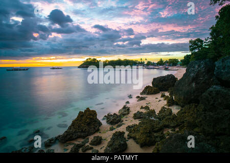 Soleil rose coloré ciel au-dessus d'une île rocheuse Paradise beach et la mer - Langob, Malapascua, Cebu - Philippines Banque D'Images