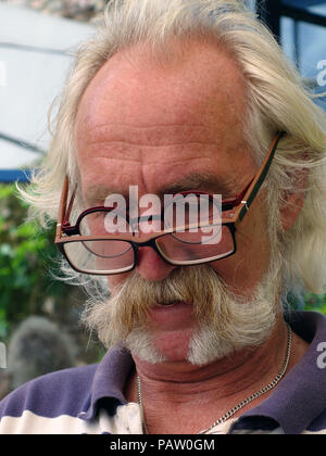 L'homme aux cheveux d'argent portant deux paires de lunettes en même temps. Propriété et parution du modèle Banque D'Images