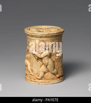 Pyxis ivoire (boîte avec couvercle). Culture : Roman. Dimensions : H. : 2 in. (5,1 cm) Diam. : 1 9/16 in. (4 cm). Date : 1er siècle de notre ère. La boîte est décorée de Cupids, ludique et le couvercle avec un buste d'une femme. Musée : Metropolitan Museum of Art, New York, USA. Banque D'Images