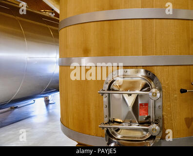 Détail de la porte d'évacuation métallique du tambour en bois à fermenter du vin avec anneaux en métal dans une vinerie d la Rioja en Espagne Banque D'Images