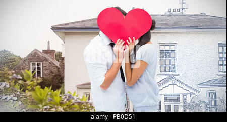 Image composite du couple couvrant leur baiser avec un coeur Banque D'Images