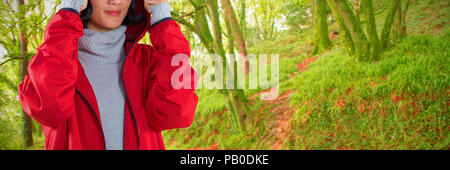 Image composite de femme en veste standing against white background Banque D'Images