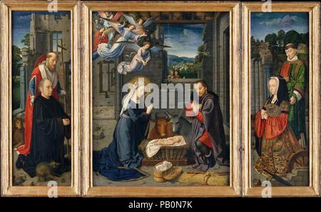 La Nativité avec les donateurs et les Saints Jérôme et Leonard. Artiste : Gérard David (Oudewater, Russisch ca. 1455-1523 Bruges). Dimensions : panneau central 35 1/2 x 28 in. (90,2 x 71,1 cm) ; chaque aile 35 1/2 x 12 3/8 in. (90,2 x 31,4 cm). Date : ca. 1510-15. David concentre l'attention sur le mystère de l'Incarnation, c'est-à-dire, la naissance du Christ et le sacrifice pour la rédemption de l'humanité. Malgré le moment de joie représentée, les chiffres portent tous des expressions sombre, préfigurant le Christ de finalement la souffrance et la mort. La gerbe de grain parallèle à la crèche fait référence à Jean 6:41 : 'Je suis le pain qui cam Banque D'Images