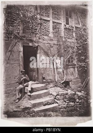 [Homme assis sur les marches de la maison avec des chaussettes accroché sur la vigne à proximité de sécher]. Artiste : Inconnu (allemand). Dimensions : 36,9 x 27,2 cm. (14 1/2 x 10 11/16 po.). Date : 1880. Musée : Metropolitan Museum of Art, New York, USA. Banque D'Images