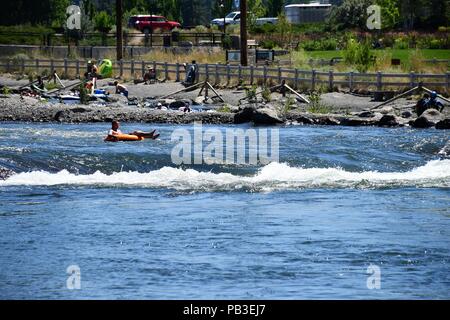 Bend, Oregon, USA. 26 juillet, 2018. River festivaliers essayez de battre les près de 100 degrés de chaleur en vous relaxant dans l'eaux froides de la rivière Deschutes. Crédit : Michael Davis/Alamy Live News Banque D'Images