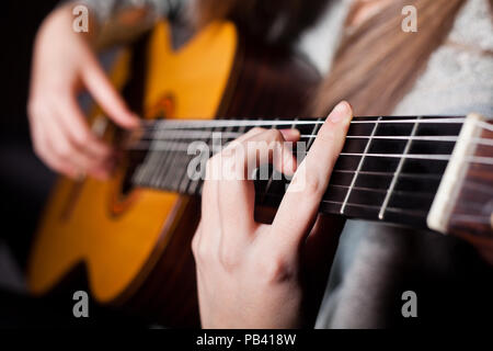 Femme jouant de la guitare acoustique Banque D'Images