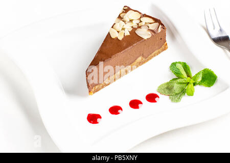 Le morceau de gâteau soufflé au chocolat à la menthe et le contre-gouttes on white plate Banque D'Images