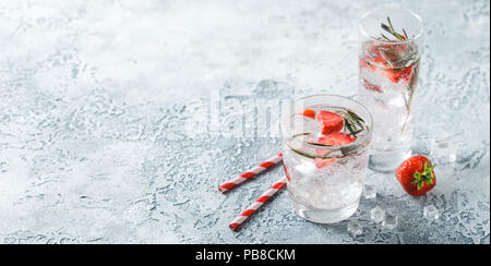 Boissons ou cocktails sans alcool avec des fraises et du romarin et de la glace dans le verre de lunettes. Bannière Concept Banque D'Images