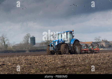 Labourer un champ avec un New Holland T7030 et d'un sillon de charrue réversible 5 Kuhn, North Yorkshire, UK. Banque D'Images