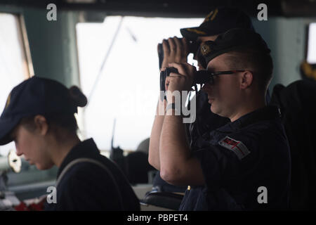 L'USS Winston S. Churchill (DDG 81) est un destroyer à missiles guidés de classe Arleigh Burke de la marine américaine mis en service en 2001. L'image d'archive documente un officier de la Royal Navy qui se tient en veille sur le pont pendant que le navire traverse le détroit du Danemark le 20 juillet 2018 lors d'opérations dans la zone de la 6e flotte américaine. Le tirage photographique historique rend compte de la coopération navale multinationale en mer. Banque D'Images