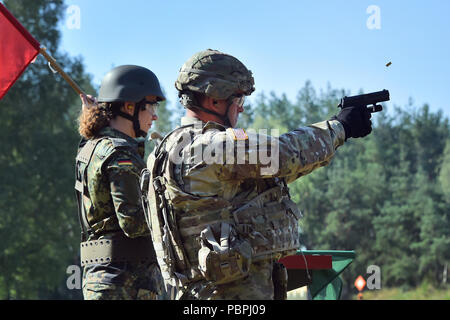 Un soldat de réserve allemande, gauche, effectue des choix de sécurité pour un soldat américain avec le 18e Bataillon de soutien au maintien en puissance de combat au cours d'une formation sur les armes allemandes, la familiarisation et l'épreuve de qualification pour démontrer l'interopérabilité et de renforcer le partenariat de la cohésion sociale à la 7e Armée, le commandement de l'aire d'entraînement Grafenwoehr, Allemagne, le 20 juillet 2018. (U.S. Photo de l'armée par Gertrud Zach) Banque D'Images