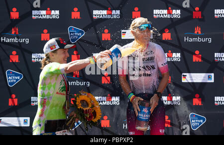 29 juillet 2018, l'Allemagne, Hambourg, triathlon, Ironman World Series : Premier placé Sarah Crowley (r) de l'Australie et de deuxième placé Katharina Grohmann de Allemagne cheer sur le podium. Photo : Daniel Reinhardt/dpa Banque D'Images