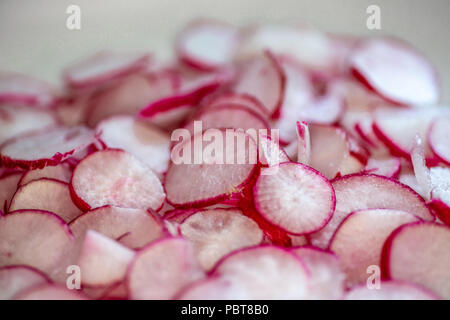 Assiette pleine de radis fraîchement coupées sur le comptoir de la cuisine en attente pour le chef d'utiliser dans une recette. Banque D'Images