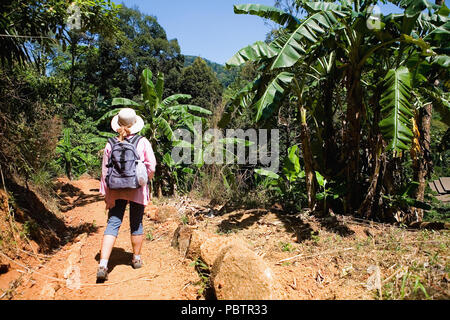 Une fille avec un sac à dos de promenades à travers la jungle. Partir en Thaïlande. Banque D'Images