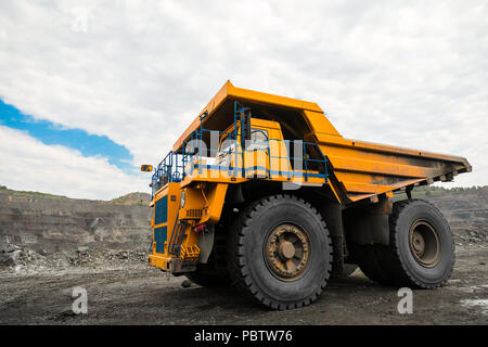 Grande carrière dump truck. Le chargement de la benne dans la roche. Chargement de charbon dans le corps chariot. Les minéraux utiles de production. Mining truck les engins d'extraction, de transport du charbon à ciel ouvert de la la production de charbon. Banque D'Images