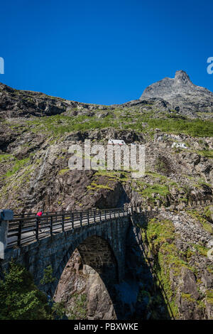 Cycliste féminine de traverser un pont sur le col trollstigen, Norvège Banque D'Images