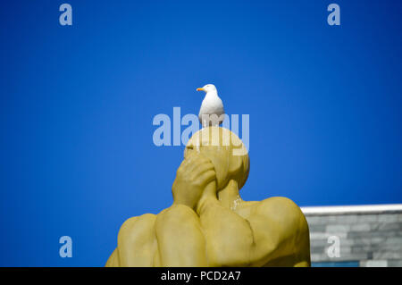 Seagull reposant sur un homme muet monument à Göteborg, Suède. Banque D'Images