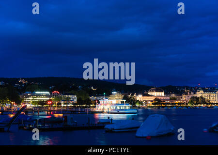 Grand bateau de croisière sur le lac de Zurich dans la nuit avec de l'eau et l'éclairage bleu ciel nuageux Banque D'Images