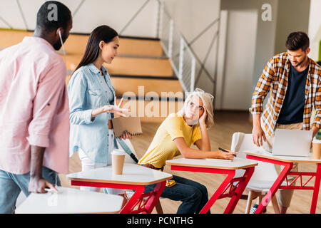 Les jeunes étudiants multiethnique de passer du temps ensemble dans la salle de conférences de l'université Banque D'Images