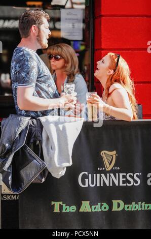 Dublin. 4 Août, 2018. Les gens aiment la bière à l'extérieur d'un bar au centre-ville de Dublin, Irlande, 3 août 2018. Le premier vendredi de chaque mois d'août marque International Beer, un événement d'encourager les gens à se retrouver entre amis et savourer le goût de la bière. Source : Xinhua/Alamy Live News Banque D'Images