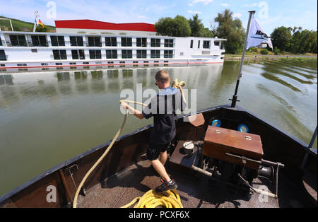 Würzburg, Allemagne. Le 04 juillet, 2018. Shipman Michl Rueckauer docks son navire ravitailleur près d'un bateau de croisière sur la rivière Main. Credit : Karl-Josef Opim/dpa/Alamy Live News Banque D'Images