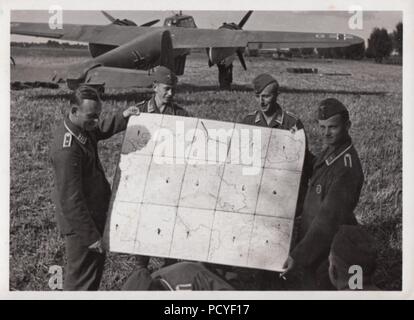 Droit de l'album photo de Gotthilf Oberfeldwebel Benseler de 9. La Kampfgeschwader 3 Staffel, équipage : de 9. La Kampfgeschwader 3 Staffel, tenir une carte de l'ouest de la Pologne, pendant la campagne contre la Pologne en septembre 1939. Dans l'arrière-plan est l'un des Dornier DO 17Z-2s du 9./KG 3. Banque D'Images