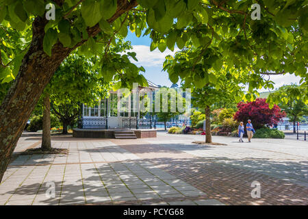 Une vue sur le kiosque dans l'avenue Royal Gardens, encadré par une branche et le tronc d'un arbre de haricots indiens à Dartmouth dans le sud du Devon, Royaume-Uni. Banque D'Images