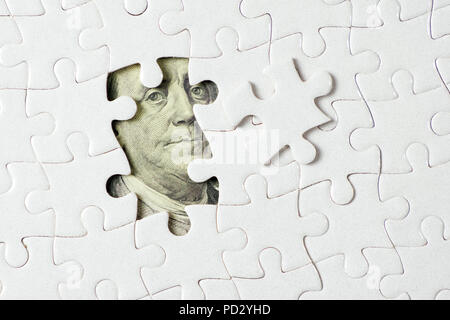 Billets en dollars US en vertu de jigsaw puzzle Banque D'Images