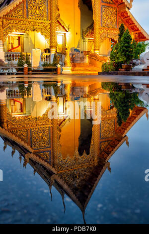 Reflet de la Wihan Luang de Wat Phra Singh dans l'eau d'une flaque, Chiang Mai, Thaïlande Banque D'Images