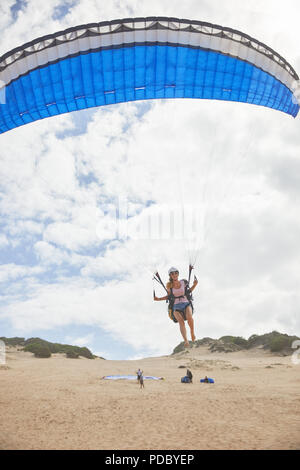 Femme parapentiste avec parachute de décoller sur beach Banque D'Images