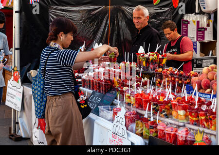 Les gens qui achètent des fruits d'un décrochage à Greenwich, Londres, Angleterre Banque D'Images