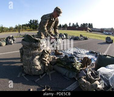 1er Sgt. Kelsey Scott, premier sergent de la Batterie B, 5e Bataillon, 3e Régiment d'artillerie, déballe son sac ruck avant la TA-50 mise en page pour la concurrence meilleur GUERRIER I Corps (BWC) au niveau du joint Base Lewis-McChord le 14 mai 2018. La Convention est tenue de mesurer les capacités techniques et tactiques bien que concurrentes dans les situations de stress élevé. Banque D'Images