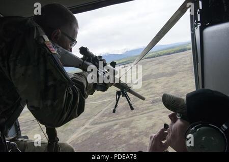 La Garde nationale du Montana Le Sgt. Jay Utter tire un M110 Sniper semi-automatique système à partir d'une garde nationale de l'Alaska UH-60 Black Hawk bien que concurrentes dans une plate-forme aérienne au cours de l'épreuve de tir meilleur guerrier de la Garde nationale La Région VI 2018 at Joint Base Elmendorf-Richardson, Alaska, le 16 mai 2018. Meilleur guerrier de la Garde nationale La Région VI 2018 est une compétition de quatre jours que des soldats tests résistance physique et mentale à travers une série d'événements qui démontrent la maîtrise technique et tactique pour déterminer le sous-officier et soldat enrôlé junior. L'competito Banque D'Images