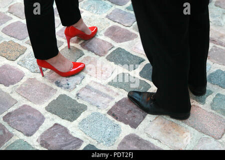 Gros plan sur les pieds d'une femme portant des talons et des pieds d'un homme portant des chaussures à puce Banque D'Images