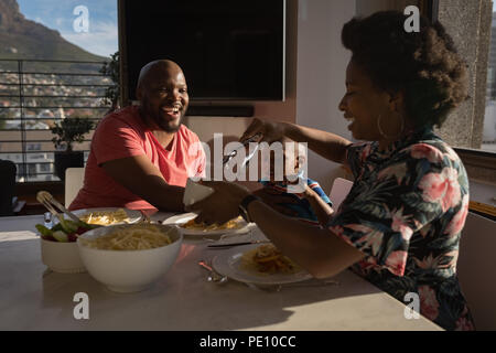 Famille de prendre le petit déjeuner sur une table à manger Banque D'Images