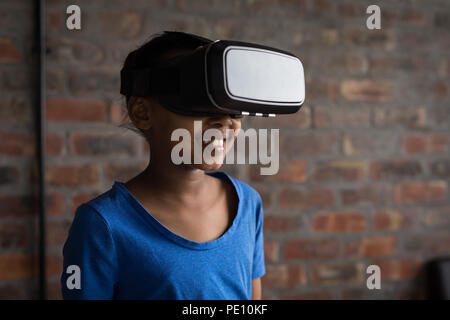 Fille à l'aide de casque de réalité virtuelle in office Banque D'Images