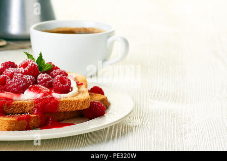 Café et des toasts avec les framboises sur tableau blanc Banque D'Images