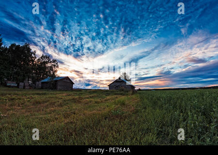 La fin de l'été le soleil se couche derrière l'ancienne grange magnifiquement maisons dans le Nord de la Finlande. Les nuits sont toujours aussi claire, mais les couchers de soleil sont quelque chose à Banque D'Images