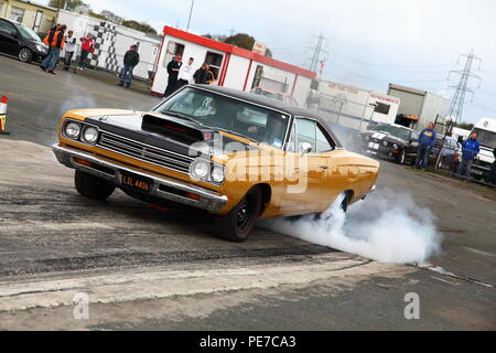 Une voiture effectuant une rotation de roue pour réchauffer les pneus avant la course sur le drag strip d'York Raceway à Melbourne,East Yorkshire Banque D'Images