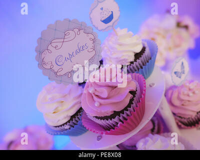 Occasion spéciale trio de cupcakes sur un gâteau à plusieurs niveaux avec l'écran dépoli rose et blanc crème, décoré d'argent pearl accessoires Banque D'Images